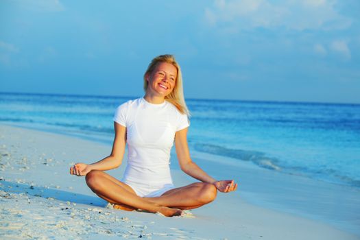 yoga woman on sea coast