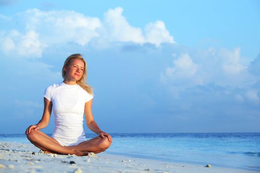 yoga woman on sea coast