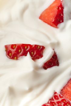 White whipped cream vanilla with pieces of strawberry