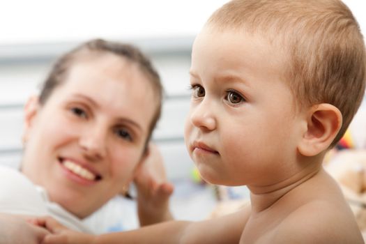 Smiling mother and little child - family happiness