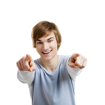 Portrait of a handsome young man looking and pointing to the camera, isolated over a white background