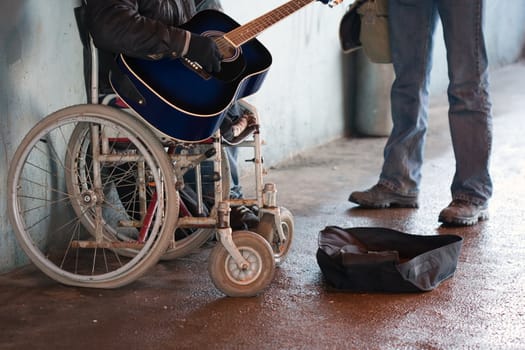 Beggar men wheelchair disabled person with guitar