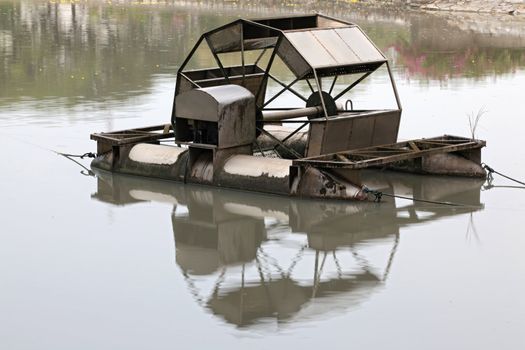 Metal wheel of watermill in Pond use for Add Oxygen for Industrial Sewerage System and water Treatment