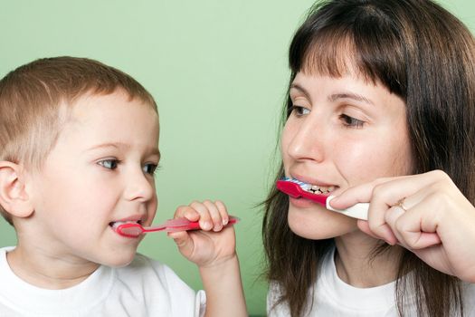 Little child and mother toothbrush brushing teeth
