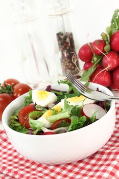 a white bowl with mixed salad