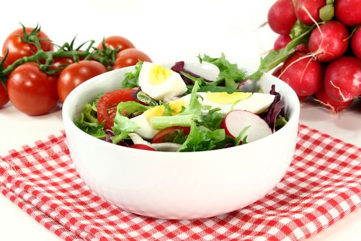 a white bowl with mixed salad