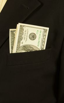 Close-up of businessman with dollar banknotes in suit pocket