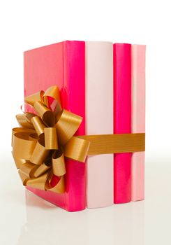 Four books tied up with ribbon on white background