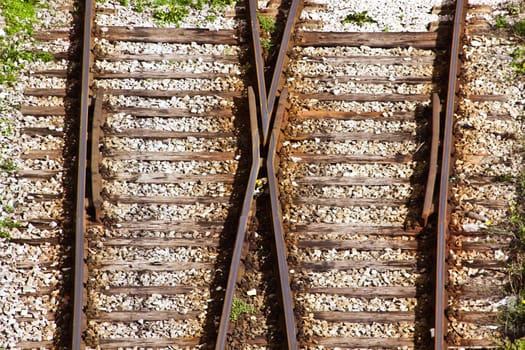 Line of railway crossing, stones, grass, port of Lisbon.