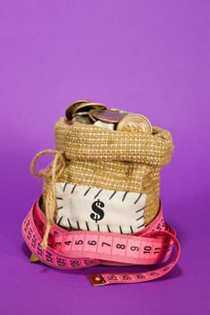 Sack full of coins over purple background