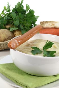 a bowl of potato soup with parsley
