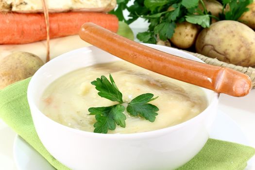 a bowl of potato soup with parsley