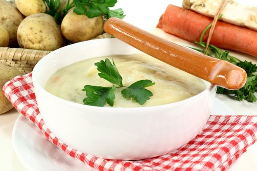 a bowl of potato soup with parsley