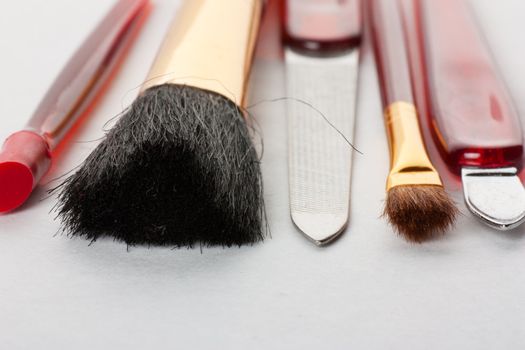 Closeup view of makeup tools: brushes and nail file