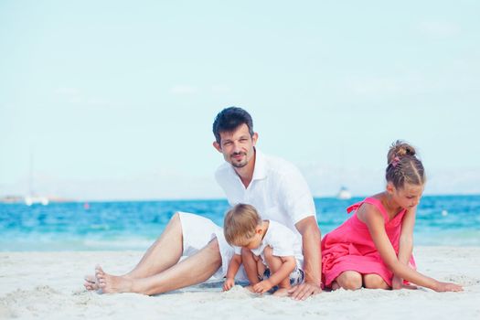 Cute father and her child playing happily at pretty beach