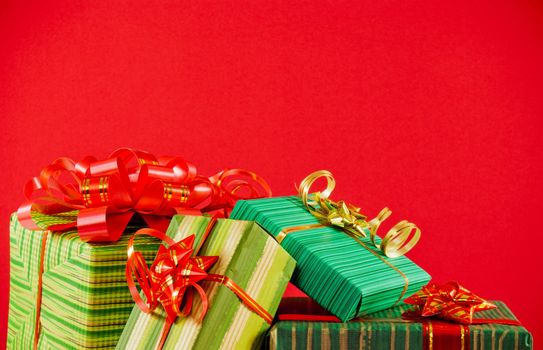 Wrapped boxes with presents against red background