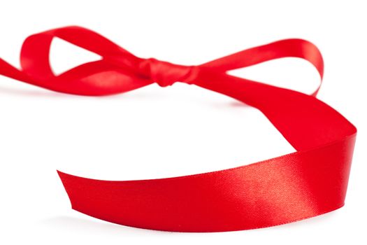 Red bow, red silk ribbon over white background