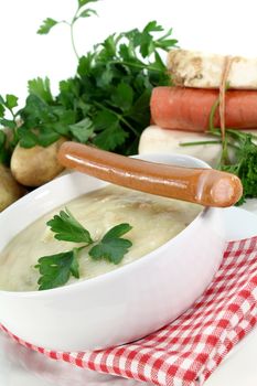 a bowl of potato soup with parsley