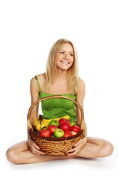 woman holds a basket of fruit on a white background