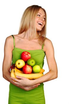 woman holds a pile of fruit on a white background