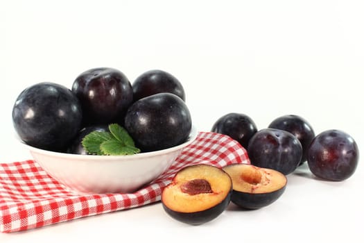 fresh plums on a white background