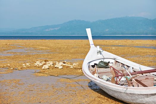 Thai national fishing wooden boat on the shore