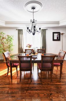 Dining room interior with wooden table and chairs in house