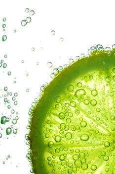 lime slice in water bubbles