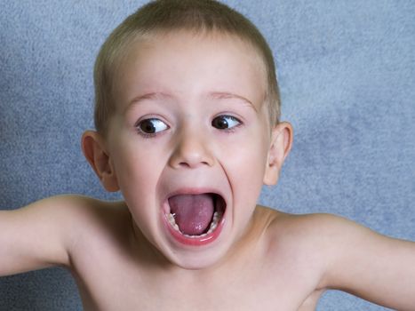 Little child boy shouting or screaming for fun