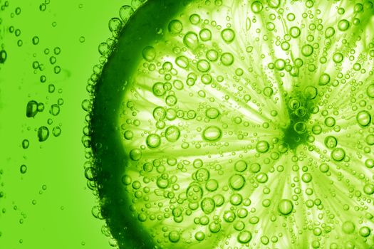 lime slice in water bubbles