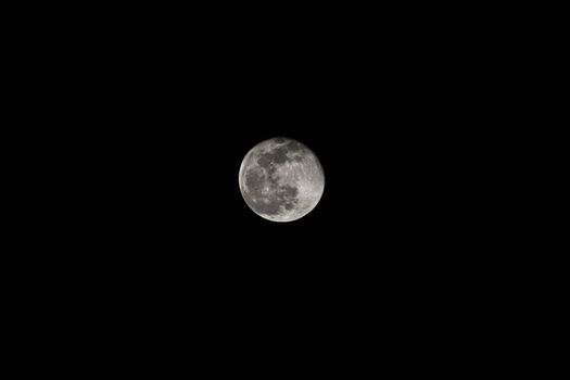 Near full moon with dark background as seen through 400mm lens