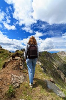 young woman is walking on Monzoni ridge, Italian Dolomites