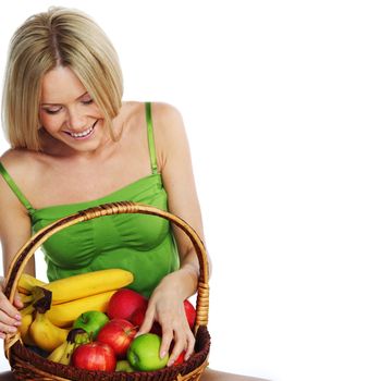 woman holds a basket of fruit on a white background