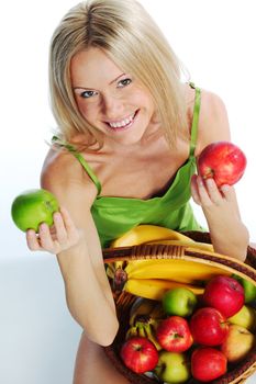 woman holds a basket of fruit on a white background