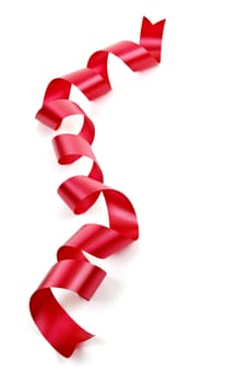 Curled red holiday ribbon strip isolated on white background