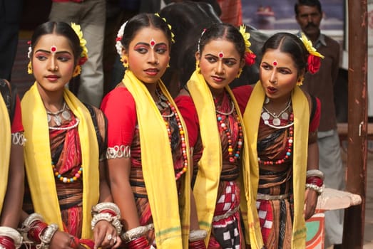 Group of teenage Indian dancers in traditional tribal outfit at the Sarujkund Craft Fair in Haryana near Delhi, India.