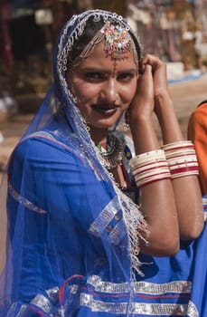Portrait of a Female Indian dancer in blue sari at the annual Sarujkund Fair near Delhi, India