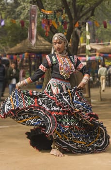 Tribal dancer in action at the annual  Sarujkund Fair near Delhi, India