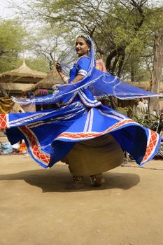 Female Tribal dancer performing at the Sarujkund Fair in Haryana near Delhi, India.