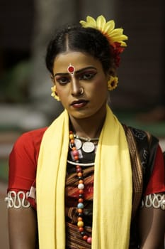 Indian dancer in traditional tribal outfit at the Sarujkund Craft Fair in Haryana near Delhi, India.