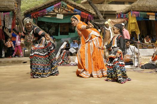 Female tribal dancers performing at the Sarujkund Fair near Delhi, India.