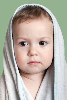 Cute little human baby child eyes on face in towel