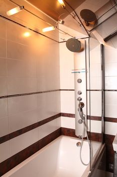 Modern bathroom finished with a white and brown tile