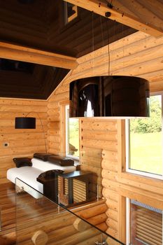 Spacious hall in the wooden house, executed in style hight-tech