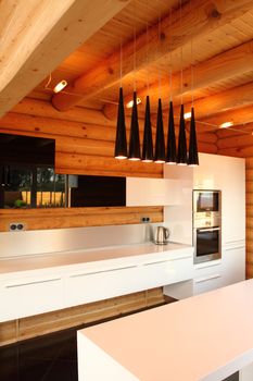 Wide kitchen in the wooden house, executed in style hight-tech