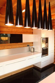 Wide kitchen in the wooden house, executed in style hight-tech