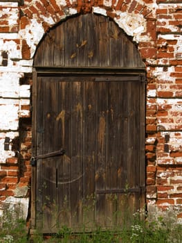 Old church closed entrance with wood door and lock