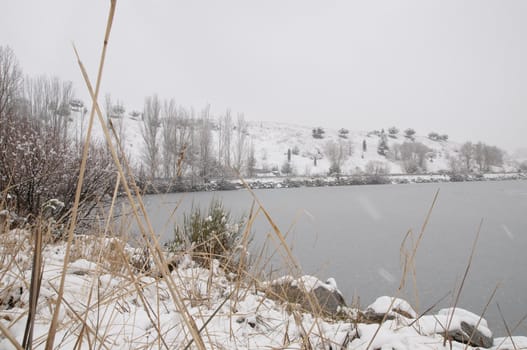 winter landscape of a frozen lake and snow