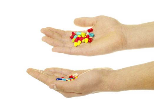 finger holds pill isolated on white