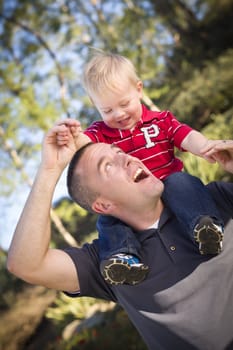 Young Laughing Father and Child  Having Piggy Back Fun.